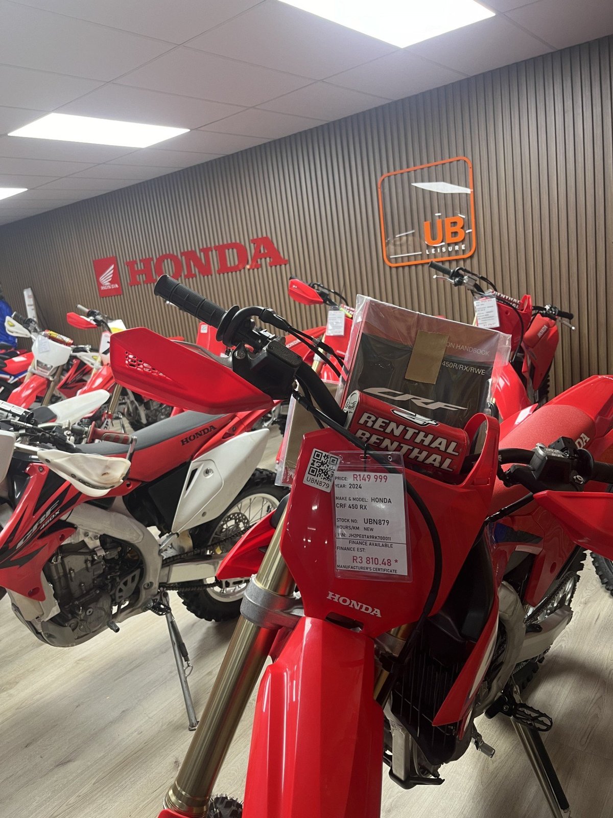Honda branded reception and showroom signage in red cut perspex letters mounted on a corrugated metal feature wall, an example of interior acrylic signage produced by Imagine Graffix in Pretoria